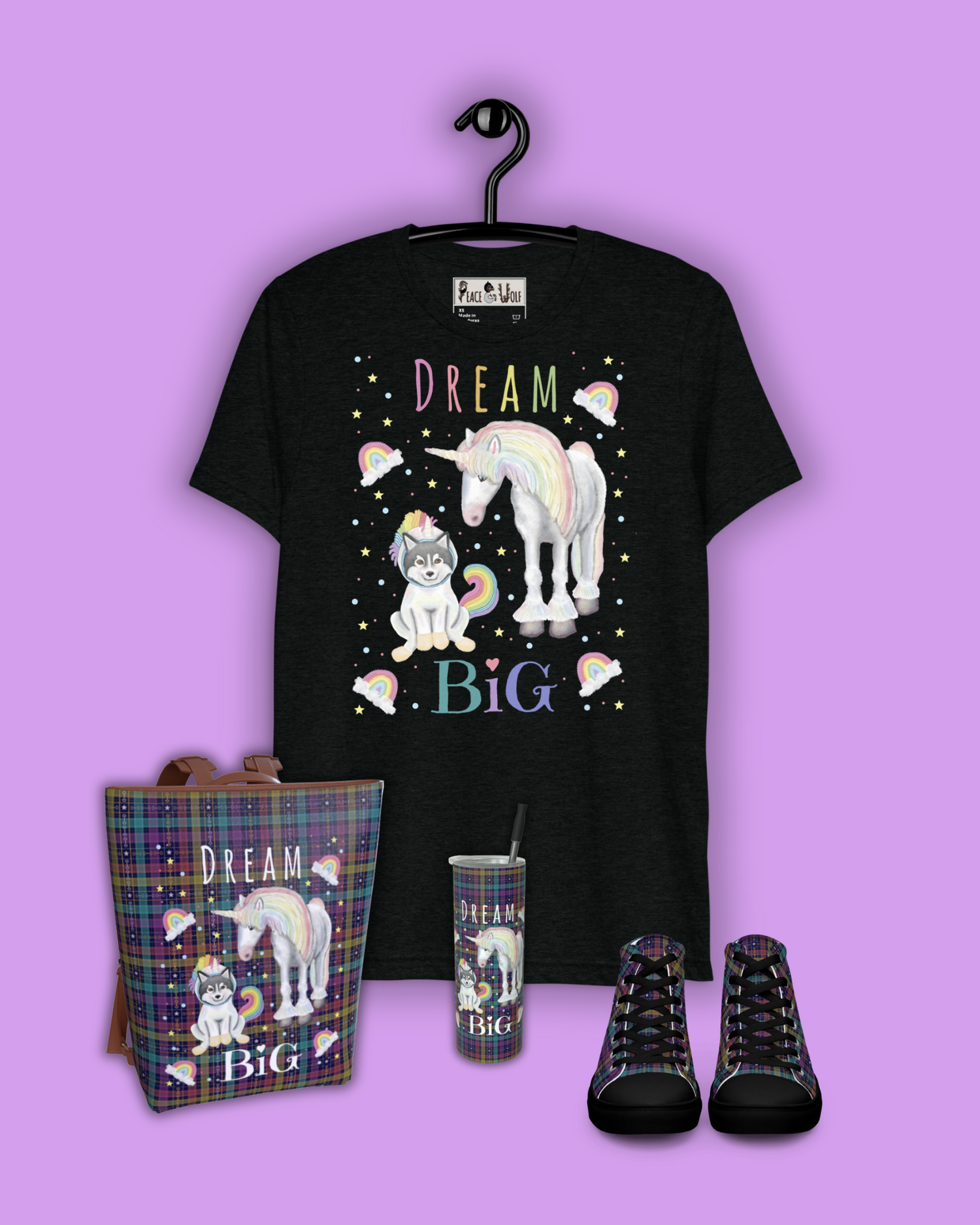 A gypsy vanner and a northern breed dog in a unicorn onesie. The words Dream Big are written across. A purple t-shirt shows this design.