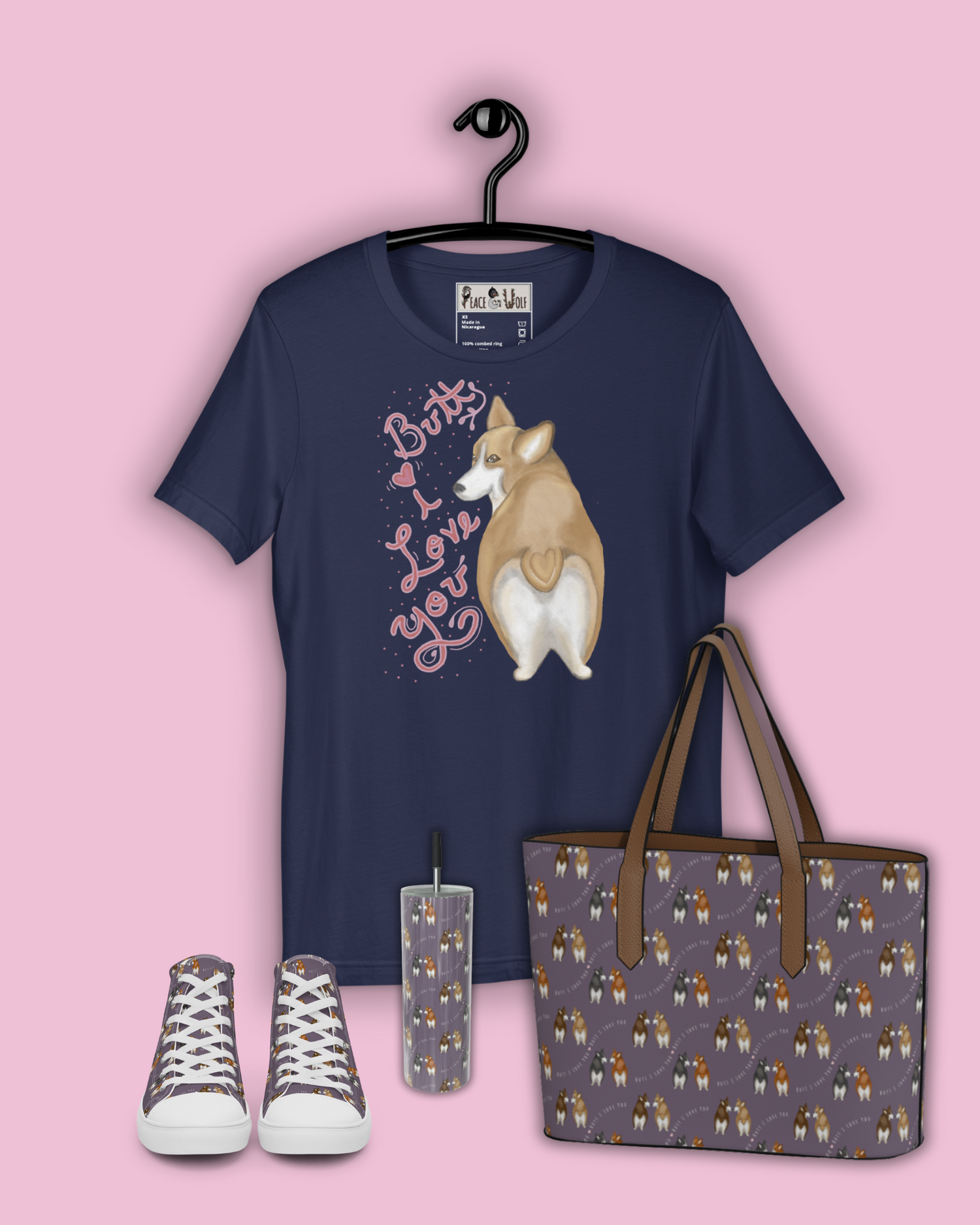 A corgi with a heart shaped butt looks back at you with cute eyes on this tees in this collection. The Words on the tops read: "Butt I Love You". The patterns in this collection feature a pink background with cute corgis and hearts.