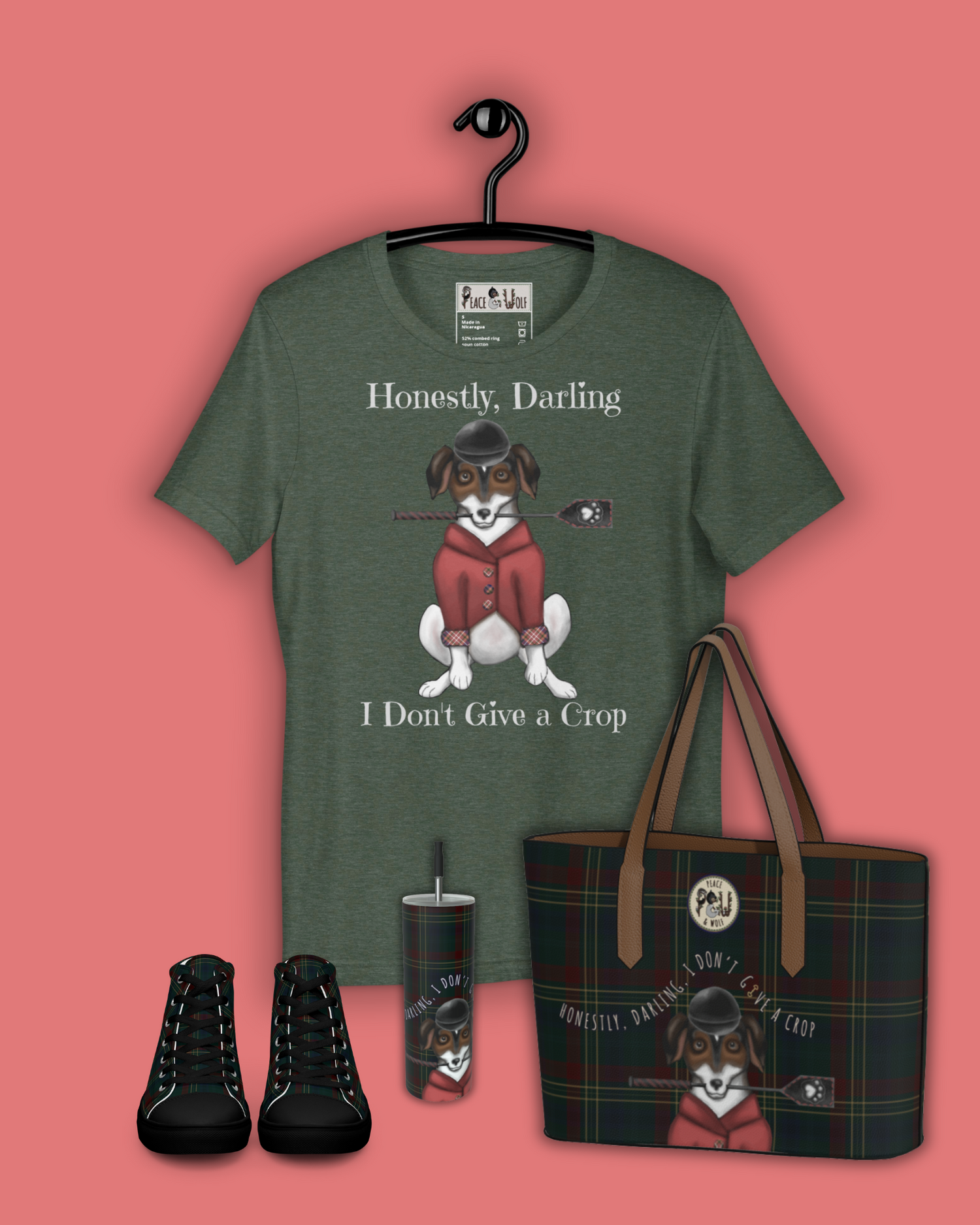 A Jack Russell Terrier sits while wearing a red equestrian show coat, a horseback riding helmet, and a crop with a paw print in its mouth.